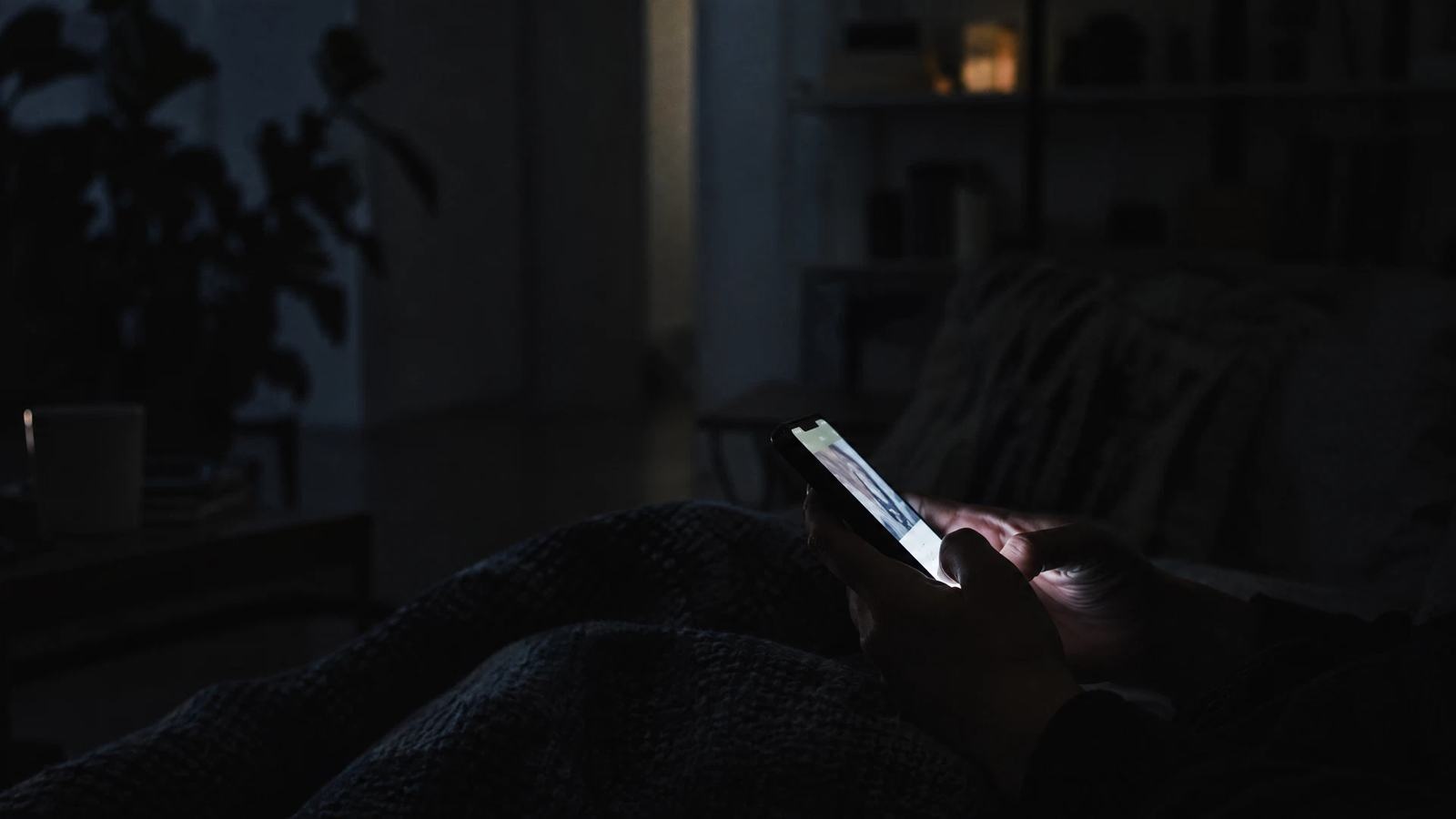 A phone illuminates a dark room as a clip travels beyond its original context.